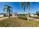 Single-story house with a well-manicured lawn and palm trees at 11134 115Th St, Largo, FL 33778