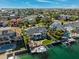 Stunning aerial shot showcasing backyard pool, private dock, boat lift, and canal front living at 123 8Th E St, Tierra Verde, FL 33715
