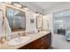 Bright bathroom with double vanity sinks, granite countertops, and modern fixtures at 123 8Th E St, Tierra Verde, FL 33715