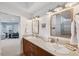 Bathroom with double sinks and neutral countertops with natural lighting at 123 8Th E St, Tierra Verde, FL 33715