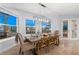 Elegant dining room featuring a waterfront view, stylish lighting, and comfortable seating for six at 123 8Th E St, Tierra Verde, FL 33715