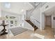 Bright foyer with staircase, skylights, and tile flooring leading to the main living areas at 123 8Th E St, Tierra Verde, FL 33715