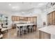 Open kitchen with a large island, modern lighting fixtures, light wood cabinets, and an open floorplan at 123 8Th E St, Tierra Verde, FL 33715