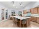 Bright kitchen featuring wood cabinets, stainless appliances, a large island with seating, and water views at 123 8Th E St, Tierra Verde, FL 33715