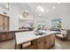 Bright kitchen featuring a large island with a sink, modern lighting, and an open floor plan at 123 8Th E St, Tierra Verde, FL 33715