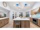 Bright and spacious kitchen with a large island, modern appliances, and a view to the water at 123 8Th E St, Tierra Verde, FL 33715