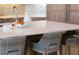 Close up of the kitchen island featuring quartz countertops, light wood, and modern chairs at 123 8Th E St, Tierra Verde, FL 33715