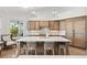 Bright kitchen featuring wood cabinets, stainless appliances, a large island with seating, and water views at 123 8Th E St, Tierra Verde, FL 33715