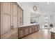 Bright kitchen features custom cabinets, a modern countertop, and a view of the water at 123 8Th E St, Tierra Verde, FL 33715