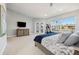 Main bedroom with a large window, ceiling fan, and access to the patio at 123 8Th E St, Tierra Verde, FL 33715