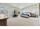 Spacious main bedroom with water views, ceiling fan, and adjacent exercise equipment at 123 8Th E St, Tierra Verde, FL 33715
