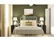 Bedroom with white metal bed frame and olive green accent wall at 12442 Sweet Angel Aura Way, Parrish, FL 34219