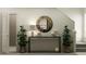 Stylish entryway with console table, mirror, and plants at 12442 Sweet Angel Aura Way, Parrish, FL 34219