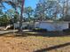 House with a yard, driveway, and surrounding trees at 12961 Sophia Cir, Largo, FL 33774