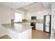 Modern kitchen with granite countertops and white cabinets at 1325 Snell Isle Ne Blvd # 407, St Petersburg, FL 33704