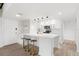Updated kitchen boasting white cabinets, quartz countertops, and a gold faucet at 1328 Pelican Creek Xing # D, St Petersburg, FL 33707