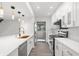 Bright kitchen with white cabinets, stainless steel appliances, and a kitchen island at 1328 Pelican Creek Xing # D, St Petersburg, FL 33707