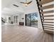 Bright living room with sliding glass doors, hardwood floors, and a modern staircase at 1328 Pelican Creek Xing # D, St Petersburg, FL 33707