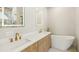 Luxurious bathroom with double sinks, quartz countertop, and a modern soaking tub at 1412 S Moody Ave # A, Tampa, FL 33629