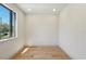 Bright bedroom with hardwood floors, large window, and neutral paint, offering a serene and inviting atmosphere at 1412 S Moody Ave # A, Tampa, FL 33629