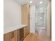 Hallway view of the kitchen featuring plenty of storage space, hardwood floors, and a wine fridge at 1412 S Moody Ave # A, Tampa, FL 33629