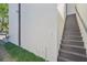 Exterior stairs going to the rooftop terrace with a white wall and green lawn at 1412 S Moody Ave # A, Tampa, FL 33629