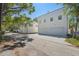 View of the back of a modern house featuring a two-car garage and a brick paved driveway at 1412 S Moody Ave # A, Tampa, FL 33629