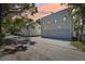 Backyard of the home with a brick driveway and a view of the garage under a colorful evening sky at 1412 S Moody Ave # A, Tampa, FL 33629