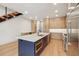 Modern kitchen with large island, stainless steel appliances, custom cabinets, and hardwood floors at 1412 S Moody Ave # A, Tampa, FL 33629