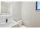 The powder room features a white vanity with lighted mirror, white marble countertop, and a modern black faucet at 1412 S Moody Ave # A, Tampa, FL 33629