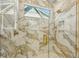 Luxurious shower with marble tile, rainfall showerhead, and a glass door offering a spa-like experience at 1412 S Moody Ave # A, Tampa, FL 33629