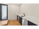 Close up of the wet bar featuring dark cabinetry, stainless steel appliances, marble countertops, and a black faucet at 1412 S Moody Ave # A, Tampa, FL 33629
