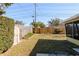 Fenced backyard with wooden shed and grassy area at 1521 San Helen Dr, Dunedin, FL 34698