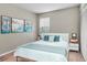 Relaxing bedroom with wood-style flooring, a comfortable bed, and nature-inspired artwork at 1799 N Highland Ave # 28, Clearwater, FL 33755