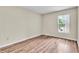 Simple bedroom with wood-look floors and a window with blinds at 1799 N Highland Ave # 28, Clearwater, FL 33755