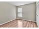 Spacious bedroom featuring wood-look flooring and large window at 1799 N Highland Ave # 28, Clearwater, FL 33755