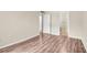 Bedroom with wood-look floors and access to hallway and closet at 1799 N Highland Ave # 28, Clearwater, FL 33755