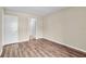 Simple bedroom with wood-look floors and access to bathroom at 1799 N Highland Ave # 28, Clearwater, FL 33755