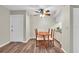 Simple dining area with wood-style flooring, a wooden table, and seating for four at 1799 N Highland Ave # 28, Clearwater, FL 33755