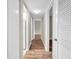 Light and bright hallway with wood-look floors and doors leading to other rooms at 1799 N Highland Ave # 28, Clearwater, FL 33755