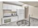 Well-equipped kitchen with white cabinets, granite countertops, and stainless steel sink at 1799 N Highland Ave # 28, Clearwater, FL 33755