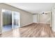 Living room with wood-look floors and sliding doors to balcony at 1799 N Highland Ave # 28, Clearwater, FL 33755