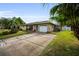 Charming single story home with a driveway and landscaping at 2404 Forecastle Dr, Palm Harbor, FL 34685