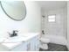 Bathroom with marble tile, white vanity, and hexagon floor tile at 2704 E 24Th Ave, Tampa, FL 33605