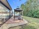 Brick paved patio with gazebo and built-in grill at 2811 Windcrest Oaks Ct, Valrico, FL 33594