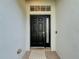 Inviting entryway with a black front door and a woven doormat at 2811 Windcrest Oaks Ct, Valrico, FL 33594