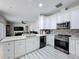 Modern kitchen with island, stainless steel appliances, and white shaker cabinets at 2811 Windcrest Oaks Ct, Valrico, FL 33594