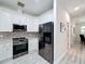 Modern kitchen with stainless steel appliances and white shaker cabinets at 2811 Windcrest Oaks Ct, Valrico, FL 33594