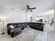 Spacious living room with sectional sofa, ceiling fan, and hardwood floors at 2811 Windcrest Oaks Ct, Valrico, FL 33594