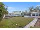 Landscaped backyard with a walkway and screened enclosure at 289 Rafael Ne Blvd, St Petersburg, FL 33704
